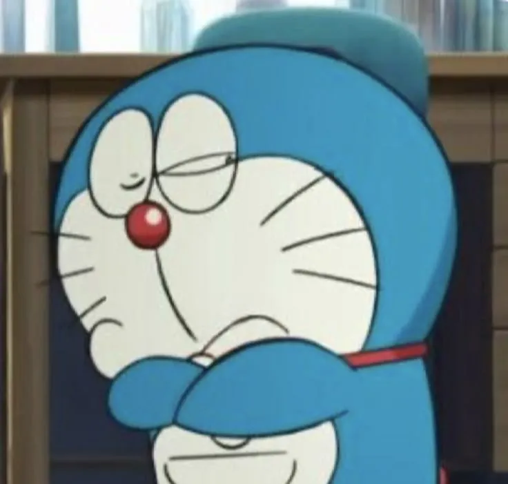 Ảnh hài Doraemon giơ tay chào Shizuka bằng nụ cười ngượng nghịu