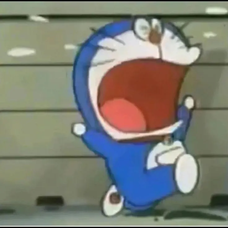 Hình vui Doraemon nhăn mặt nhìn bài kiểm tra thảm họa
